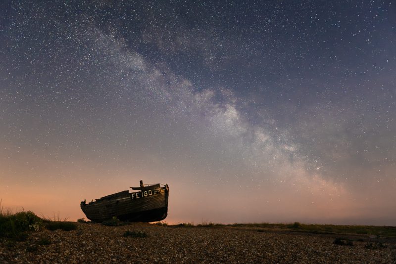Abandoned boat under the Milky Way
